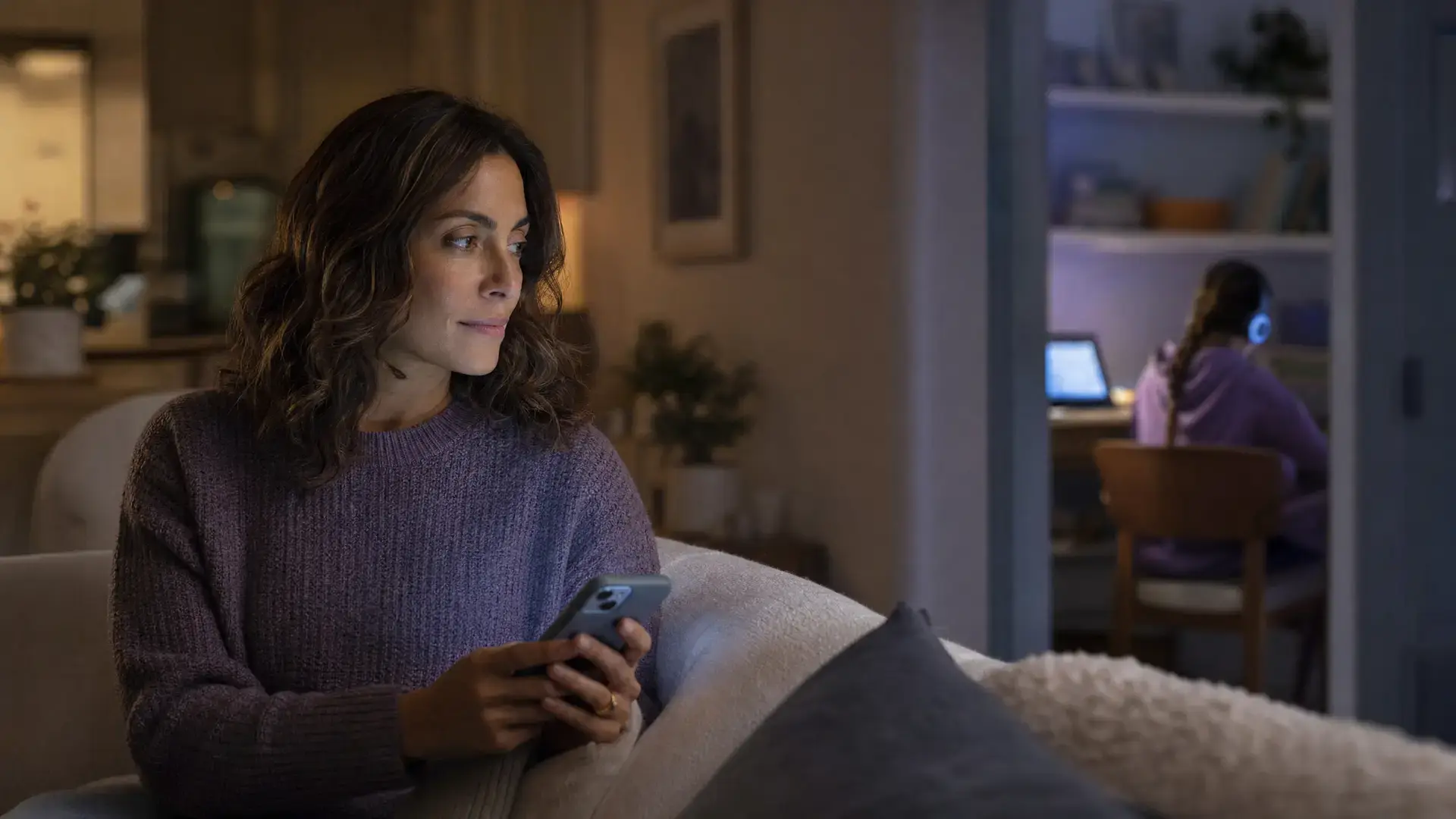 A parent and child setting up voice chat parental controls together on a phone at home